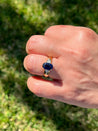 2.32 Carat Oval Cut Blue Sapphire with Trillion Cut Diamond Side stones in 18k Yellow Gold Ring